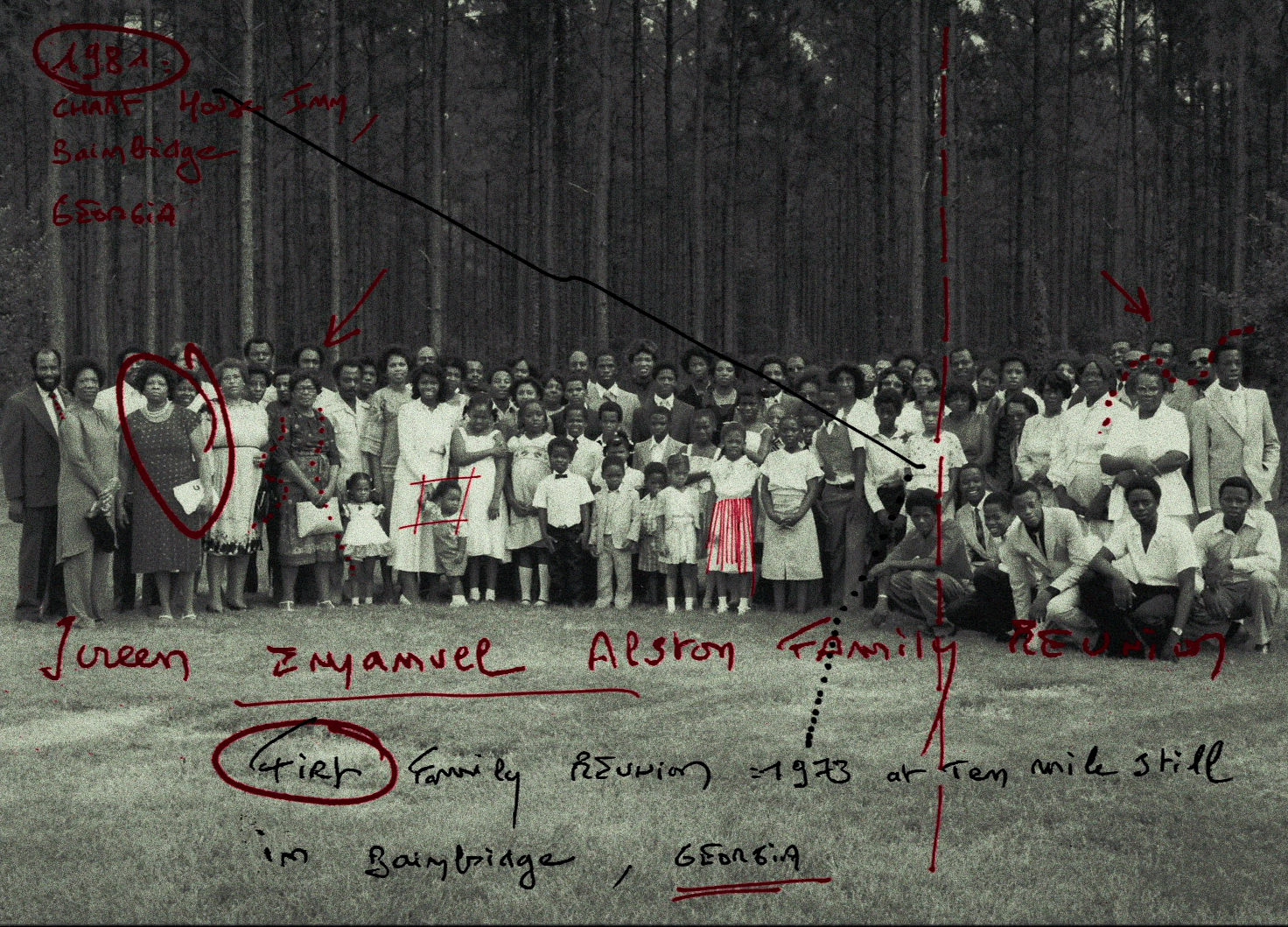 Large group family photo set against woods backdrop